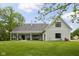 Rear view of the home featuring the covered patio, large windows and lush backyard at 8555 S County Road 375 E, Mooresville, IN 46158