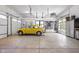 Bright garage with storage and hanging wall organizers with a yellow bug at 8555 S County Road 375 E, Mooresville, IN 46158