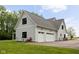 Exterior view of the garages on the home's side showing garage doors and drive at 8555 S County Road 375 E, Mooresville, IN 46158