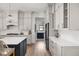 Well-appointed kitchen featuring a large island, stainless steel refrigerator, and shaker-style cabinets at 8555 S County Road 375 E, Mooresville, IN 46158