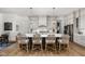 Stylish kitchen boasts an island with seating, modern pendant lighting, and pristine hardwood flooring at 8555 S County Road 375 E, Mooresville, IN 46158