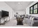 Spacious living room featuring comfortable sofas, neutral carpet, a ceiling fan, and a large window at 8555 S County Road 375 E, Mooresville, IN 46158