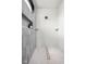 Walk-in shower featuring tile walls, modern fixtures, and convenient built-in shelving at 8555 S County Road 375 E, Mooresville, IN 46158