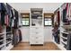 Organized walk-in closet featuring custom shelving, drawers, hanging racks, and natural light from two windows at 8555 S County Road 375 E, Mooresville, IN 46158