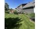 Spacious backyard featuring a deck, manicured lawn, and mature plants at 8655 Chateaugay Dr, Indianapolis, IN 46217