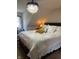 Elegant bedroom showcasing a crystal chandelier and a luxurious bed with decorative pillows and plush white linens at 8655 Chateaugay Dr, Indianapolis, IN 46217