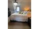 Charming bedroom with a large bed, soft lighting, and a view from the window with decorative lace curtains at 8655 Chateaugay Dr, Indianapolis, IN 46217