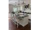 Bright kitchen with white cabinets, dark countertops, and pendant lighting at 8655 Chateaugay Dr, Indianapolis, IN 46217