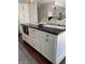 Kitchen island featuring a dark countertop, storage drawers, and modern seating at 8655 Chateaugay Dr, Indianapolis, IN 46217