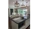 Bright kitchen with white cabinets, dark countertops, and pendant lighting at 8655 Chateaugay Dr, Indianapolis, IN 46217