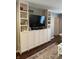 Living room with built-in shelving surrounding a TV, offering ample storage and entertainment space at 8655 Chateaugay Dr, Indianapolis, IN 46217