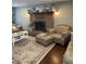 Inviting living room with brick fireplace, hardwood floors, and comfortable seating, creating a warm and welcoming space at 8655 Chateaugay Dr, Indianapolis, IN 46217