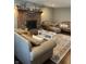 Comfortable living room with a brick fireplace, hardwood floors, and plush seating, perfect for relaxation at 8655 Chateaugay Dr, Indianapolis, IN 46217