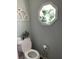 Cozy powder room with octagon window and decorative touches, offering a blend of comfort and style at 8655 Chateaugay Dr, Indianapolis, IN 46217