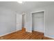 Empty bedroom with hardwood floors, closet and an open door at 895 W Poplar St, Zionsville, IN 46077
