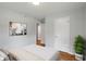 Bedroom featuring hardwood floors, neutral wall paint, bed, painting and a plant at 895 W Poplar St, Zionsville, IN 46077