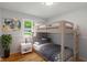 Bright bedroom features a wooden bunk bed, hardwood floors, and natural light from the window at 895 W Poplar St, Zionsville, IN 46077