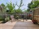 Outdoor deck features outdoor seating with chairs and small table with hanging flowers to add elegance at 895 W Poplar St, Zionsville, IN 46077