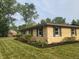 Charming single-story house with yellow brick, green shutters, and well-maintained landscaping at 895 W Poplar St, Zionsville, IN 46077