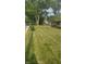Beautifully landscaped front yard with lush lawn and tidy flower beds, complementing the house at 895 W Poplar St, Zionsville, IN 46077