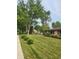 Beautifully landscaped front yard with lush lawn and tidy flower beds, complementing the house at 895 W Poplar St, Zionsville, IN 46077