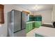 Charming kitchen with custom green cabinets, subway tile backsplash, stainless steel appliances, and white countertop at 895 W Poplar St, Zionsville, IN 46077