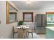 Modern kitchen featuring stainless steel appliances and marble floors next to a dining area at 895 W Poplar St, Zionsville, IN 46077