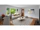 Inviting living room featuring gleaming hardwood floors, large windows, modern decor, and stylish furnishings at 895 W Poplar St, Zionsville, IN 46077
