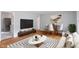 Bright living room with hardwood floors, furnished with a dining table, TV and sofa set at 895 W Poplar St, Zionsville, IN 46077