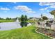 Outdoor space with a white deck offering tranquil pond views with fountain feature, and beautiful garden bed at 896 Fairfield Dr, Greenfield, IN 46140