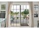 A view through the sliding glass door of the backyard deck with water feature at 896 Fairfield Dr, Greenfield, IN 46140