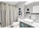 Well-lit bathroom with vessel sink, shower with curtain, and a gray color scheme at 896 Fairfield Dr, Greenfield, IN 46140
