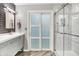 Bathroom showcasing a modern sliding door shower and vanity with sleek fixtures at 896 Fairfield Dr, Greenfield, IN 46140