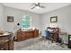 Bedroom featuring carpeted floors, a ceiling fan and a large window offering natural light at 896 Fairfield Dr, Greenfield, IN 46140