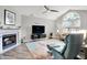 Cozy living room with fireplace, vaulted ceiling, and a large window for natural light at 896 Fairfield Dr, Greenfield, IN 46140