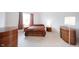 Bright bedroom with neutral walls, carpet, and stylish wooden furniture at 9117 Thoreau Ct, Fishers, IN 46037