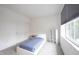 Clean bedroom featuring a bed with blue blanket, and a window providing natural light at 9117 Thoreau Ct, Fishers, IN 46037
