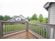 Outdoor deck with wooden railing shows beautiful landscaping and nearby home exteriors at 9117 Thoreau Ct, Fishers, IN 46037