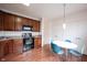 Kitchen showcasing wood cabinets, black appliances, and bright lighting at 9117 Thoreau Ct, Fishers, IN 46037