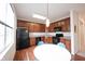 Eat-in kitchen featuring wood cabinets, black appliances, and bright natural lighting at 9117 Thoreau Ct, Fishers, IN 46037