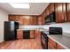 Kitchen featuring wood cabinets, black appliances, and neutral countertops at 9117 Thoreau Ct, Fishers, IN 46037
