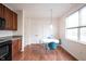 Kitchen and dining area featuring wood cabinets, black appliances, and bright window at 9117 Thoreau Ct, Fishers, IN 46037