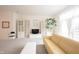 Spacious living room with media center and tree by a large window for natural light at 9117 Thoreau Ct, Fishers, IN 46037
