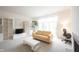 Bright living room with media center, desk space, tree, and fireplace at 9117 Thoreau Ct, Fishers, IN 46037