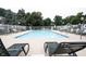 Inviting community pool surrounded by lounge chairs and lush trees at 9117 Thoreau Ct, Fishers, IN 46037