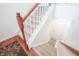 Carpeted staircase with wood railing and white spindles leading to the upper level at 9117 Thoreau Ct, Fishers, IN 46037