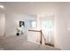 Bright upstairs hallway with neutral carpet and view of the entry area at 9117 Thoreau Ct, Fishers, IN 46037