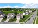 Aerial photograph of homes in a residential neighborhood, emphasizing the well-kept lawns and proximity to a green field and trees at 9717 Chuckwalla Pl, Fishers, IN 46040