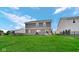 Expansive backyard with lush green grass, patio area, and the rear of a well-maintained two-story home at 9717 Chuckwalla Pl, Fishers, IN 46040
