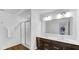Well-lit bathroom with double sink vanity, sleek countertops, a glass-enclosed shower, and modern fixtures at 9717 Chuckwalla Pl, Fishers, IN 46040